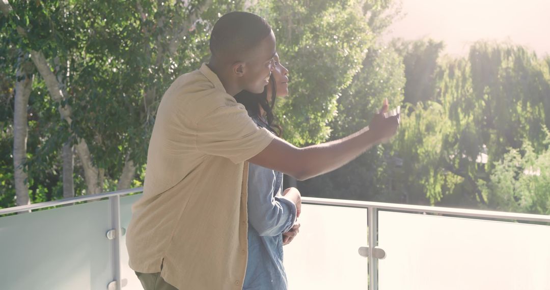 Couple Relaxing on Balcony Overlooking Scenic View in Daylight