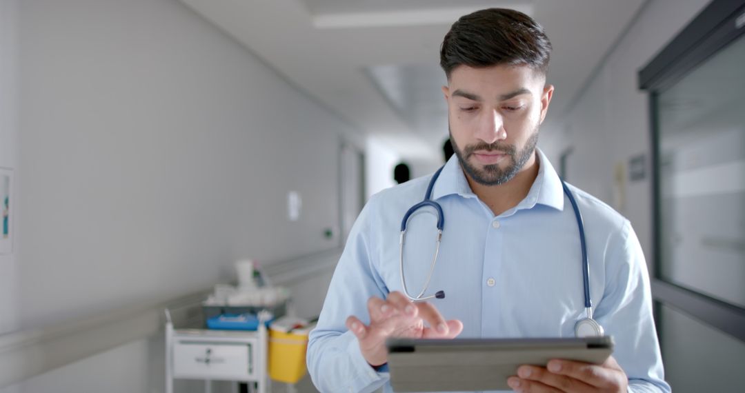Focused Doctor Reviewing Patient Data on a Tablet in Hospital