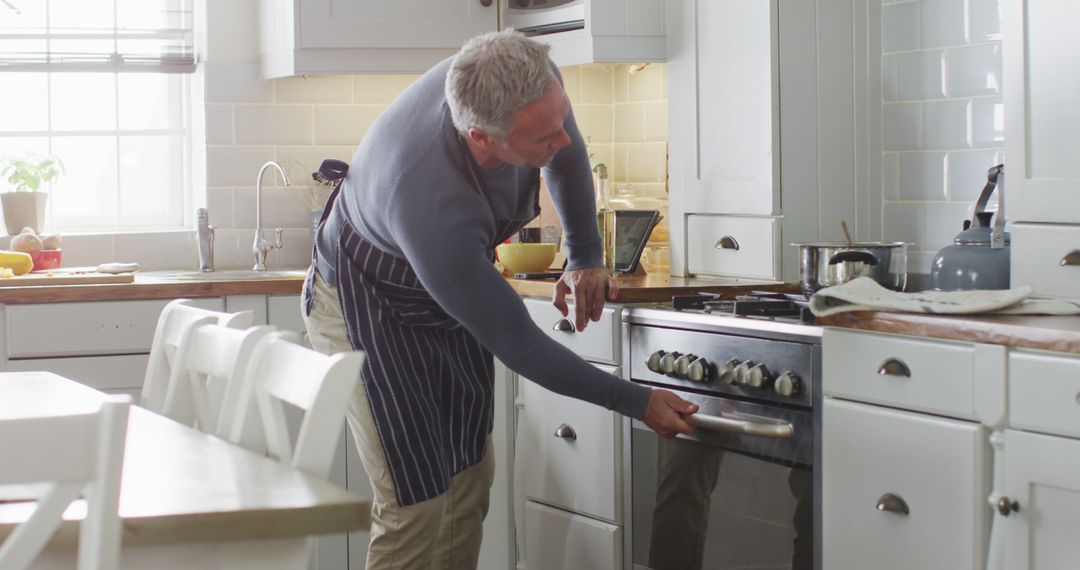 Mature Man Cooking in Modern Kitchen - Free Images, Stock Photos and Pictures on Pikwizard.com