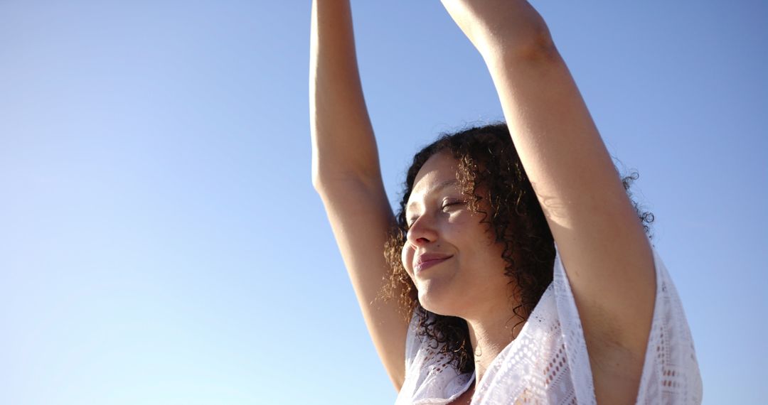 Young Woman Stretching Under Clear Sky Radiating Freedom