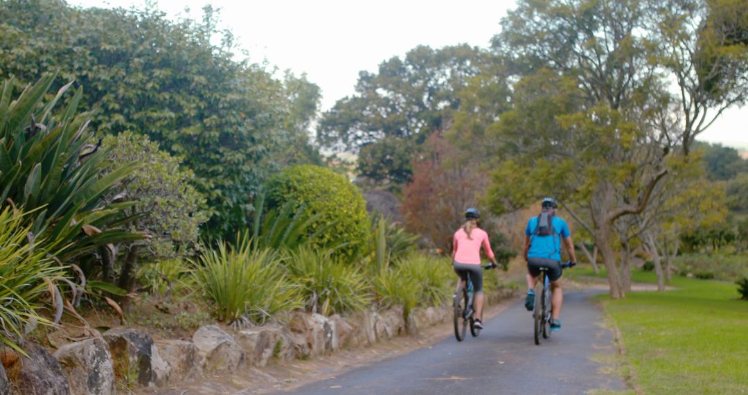 Couple Enjoying Cycling in Park - Free Images, Stock Photos and Pictures on Pikwizard.com