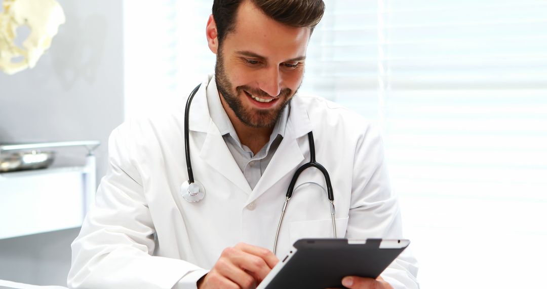 Smiling Doctor Using Tablet in Bright Office - Free Images, Stock Photos and Pictures on Pikwizard.com