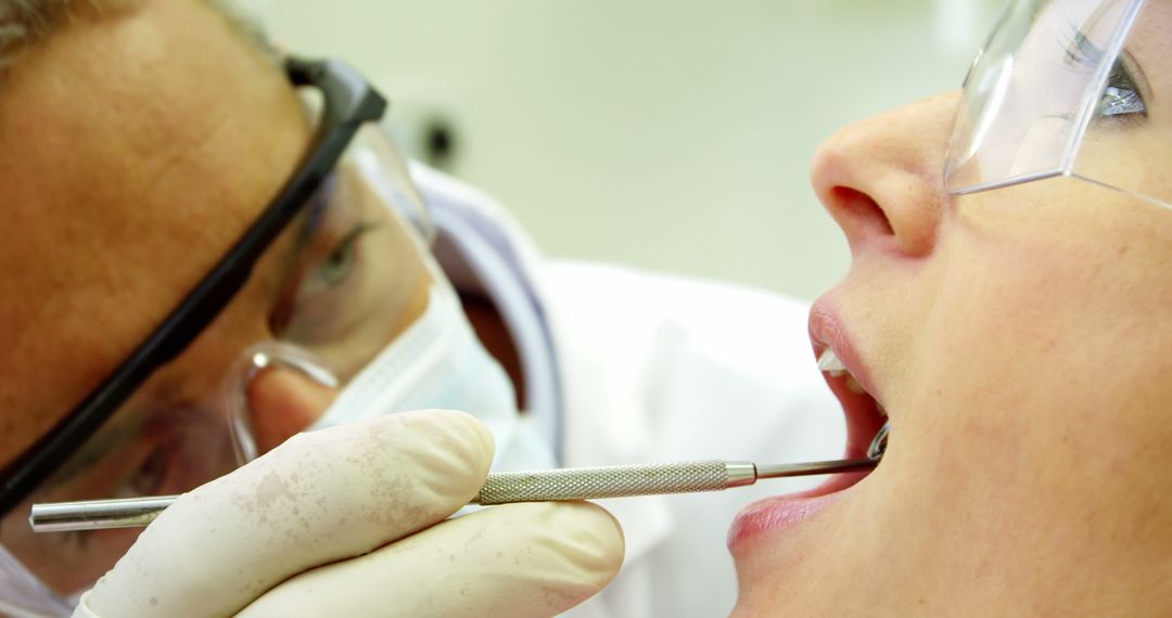 Dentist Examining Patient Teeth Close-Up with Dental Mirror - Free Images, Stock Photos and Pictures on Pikwizard.com