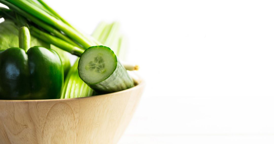 Fresh Green Vegetables in Wooden Bowl on White Backdrop