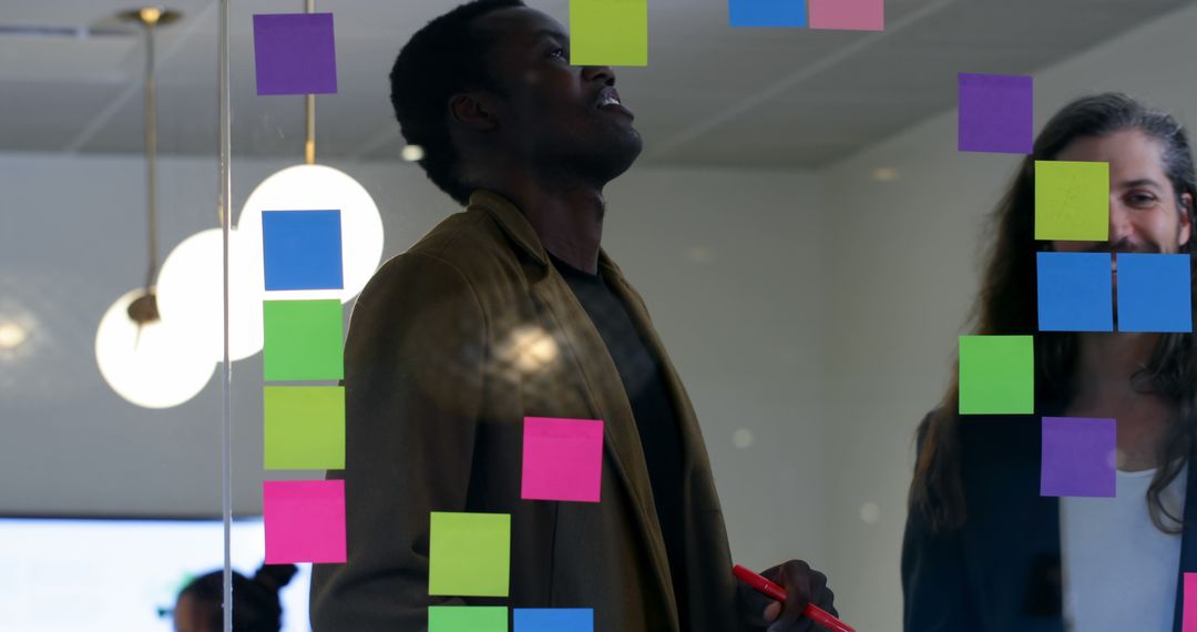 Business Team Brainstorming with Colorful Sticky Notes in Office