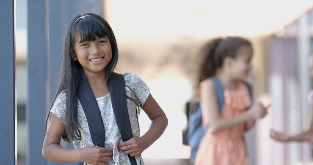Joyful Student Standing outside School Holding Backpack