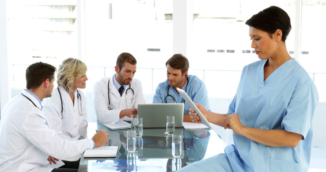 Multiracial Medical Team Reviewing Documents in Hospital Meeting Room - Free Images, Stock Photos and Pictures on Pikwizard.com