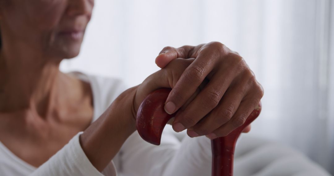 Elderly Woman's Hands Resting on Wooden Cane in Home - Free Images, Stock Photos and Pictures on Pikwizard.com