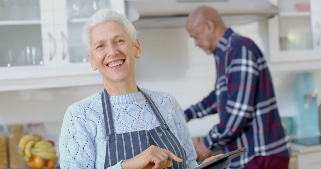 Elderly Couple Enjoying Cooking with Tablet in Modern Kitchen