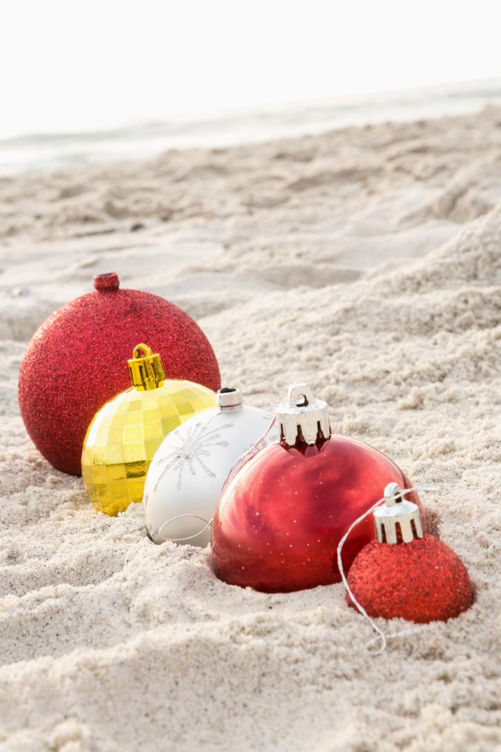Christmas baubles arranged on the sand - Free Images, Stock Photos and Pictures on Pikwizard.com