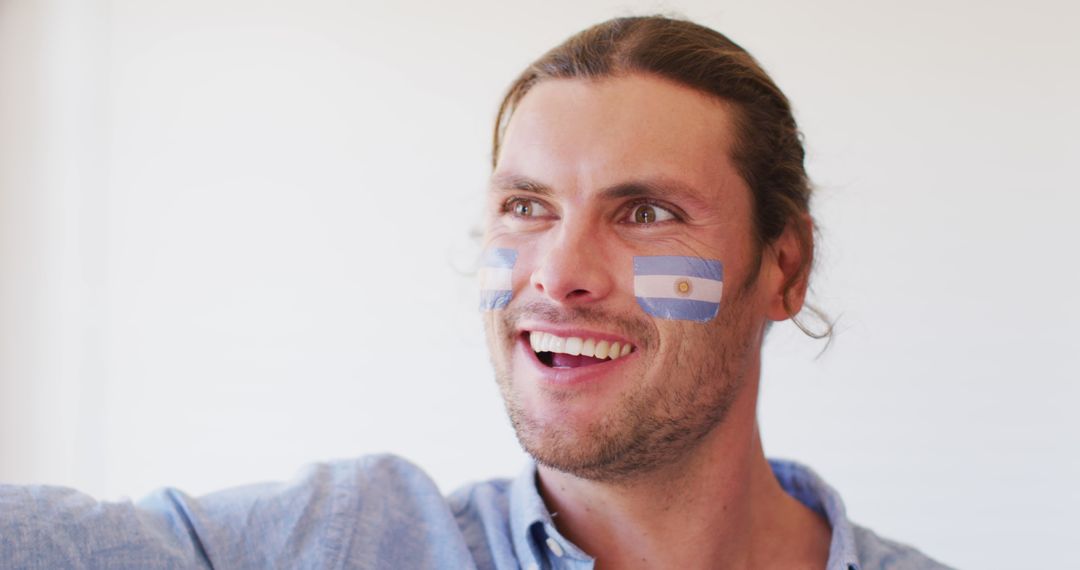 Excited Sports Fan with Argentina Face Paint - Free Images, Stock Photos and Pictures on Pikwizard.com