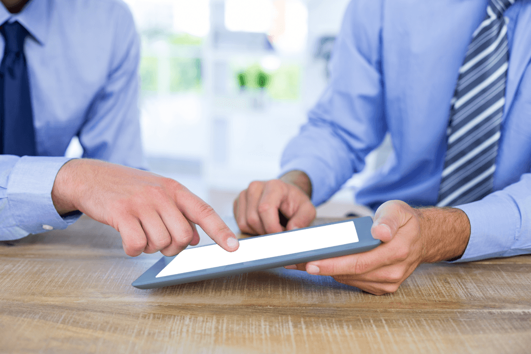 Transparent Tablet Usage by Businessmen Collaborating in Office