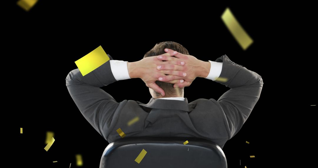 Confident Businessman Relaxing as Gold Confetti Falls