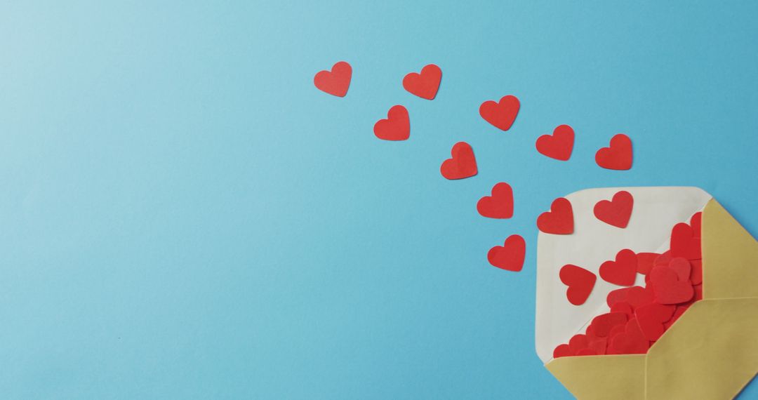 Envelope Releasing Red Paper Hearts on Blue Background