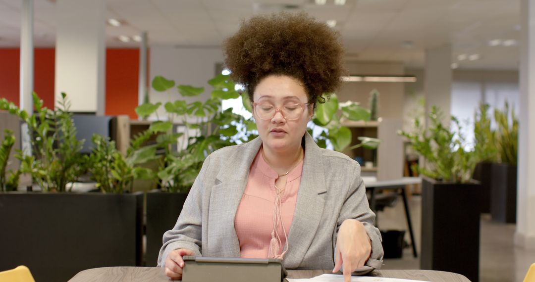 Businesswoman Reviewing Documents in Modern Office - Free Images, Stock Photos and Pictures on Pikwizard.com