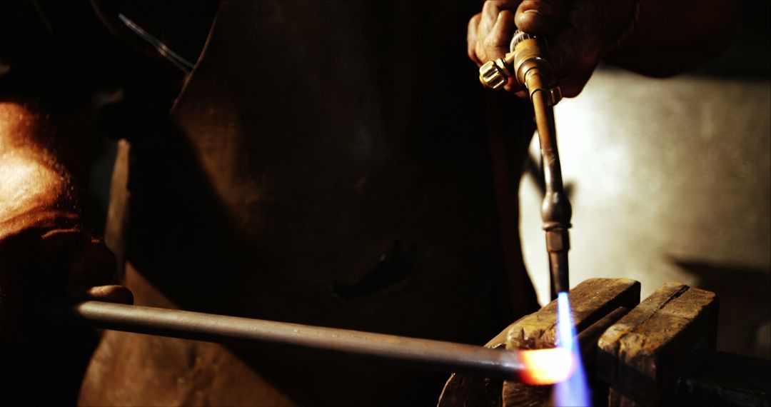 Blacksmith Heating Metal with Torch in Workshop - Free Images, Stock Photos and Pictures on Pikwizard.com