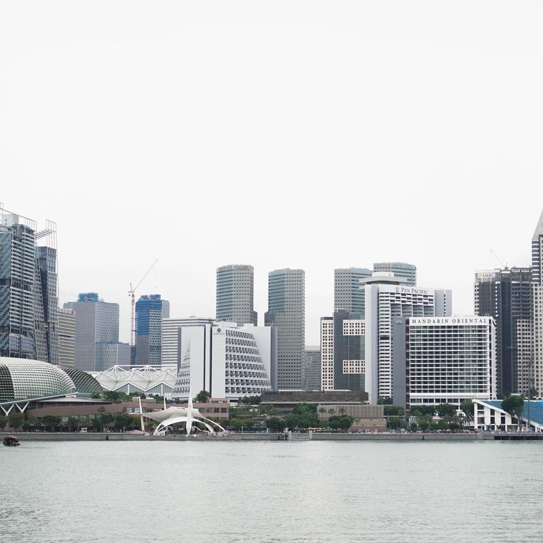 Modern Singapore Waterfront Skyline with Skyscrapers on Overcast Day - Free Images, Stock Photos and Pictures on Pikwizard.com