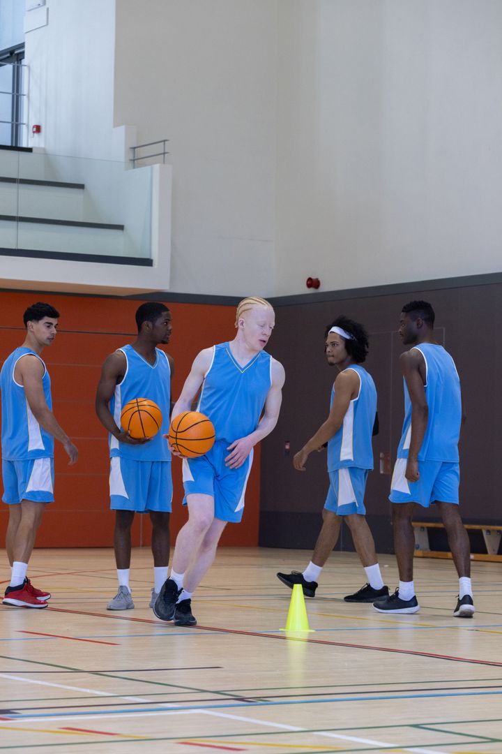 Diverse Basketball Team Preparing Drill in Gymnasium