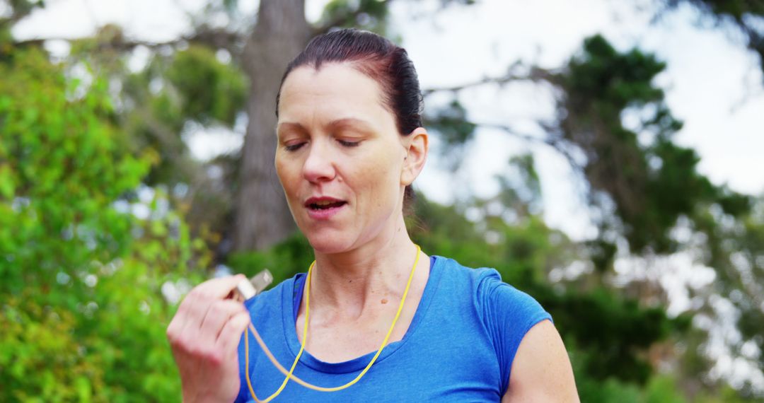 A dedicated middle-aged woman takes a breather during her outdoor jog, embodying fitness. - Free Images, Stock Photos and Pictures on Pikwizard.com