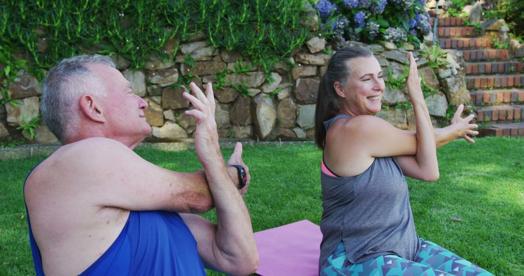 Caucasian senior couple performing stretching exercise together in the garden - Free Images, Stock Photos and Pictures on Pikwizard.com