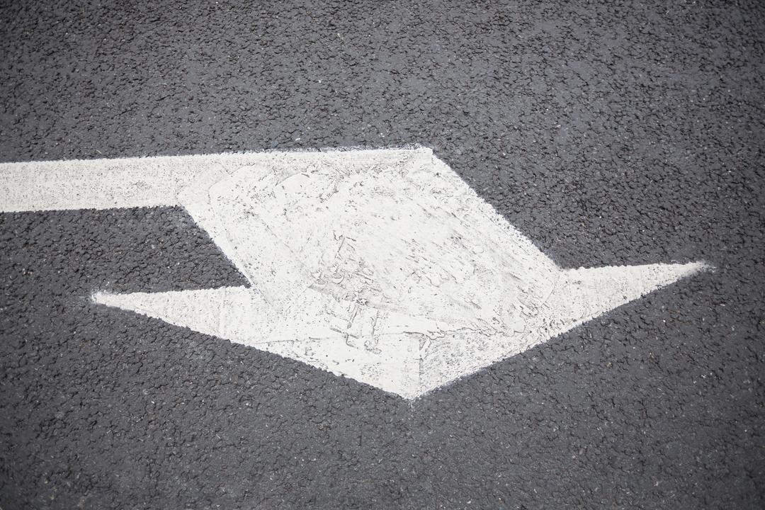 Directional Arrow Sign on Asphalt Road Surface Indicating Traffic Flow - Free Images, Stock Photos and Pictures on Pikwizard.com