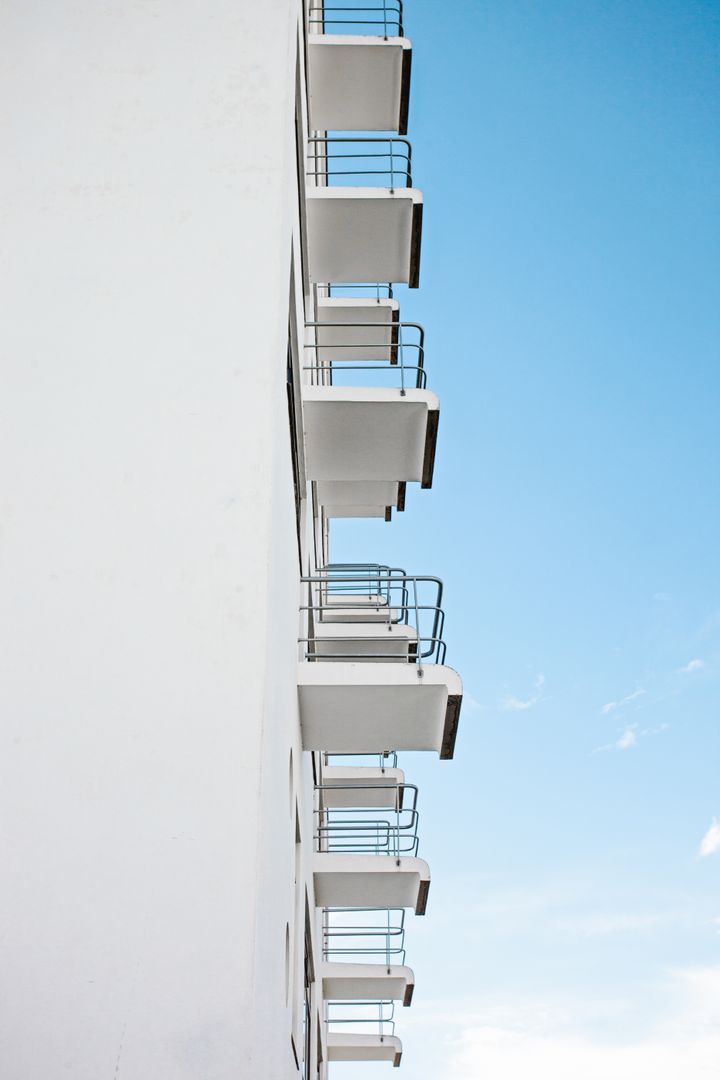 Modern Building Facade with Minimalist Balconies Against Blue Sky - Free Images, Stock Photos and Pictures on Pikwizard.com