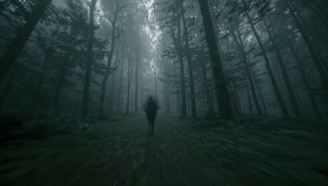 Solitary Figure Walking Through Mystical Foggy Forest