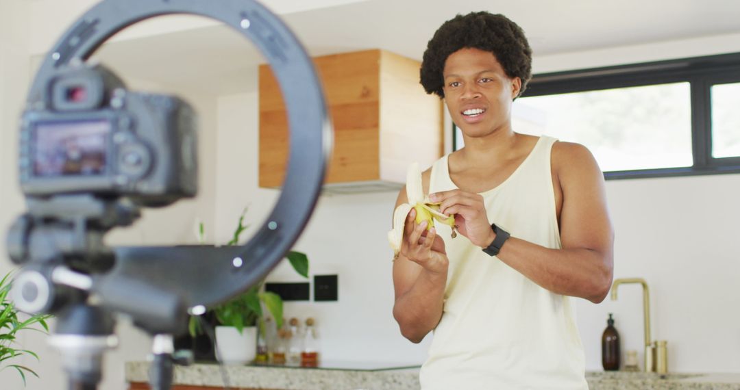 Man Filming Vlog Preparing Banana Smoothie in Kitchen