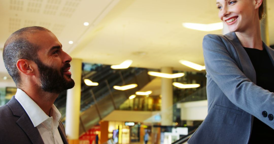 Business Professionals Discussing While on Airy Modern Escalator