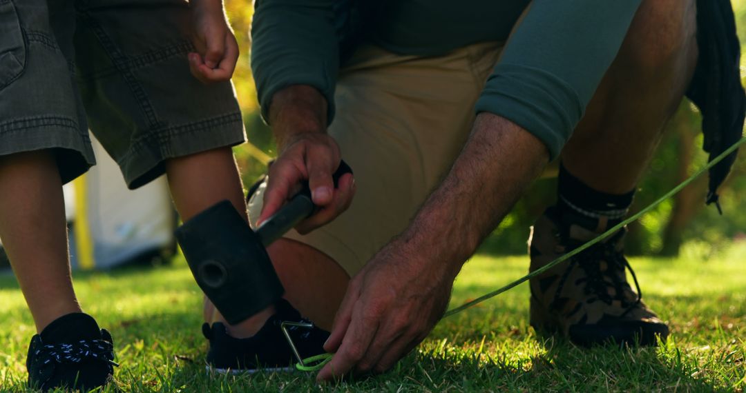 Father and son setting up tent poles in backyard together - Free Images, Stock Photos and Pictures on Pikwizard.com