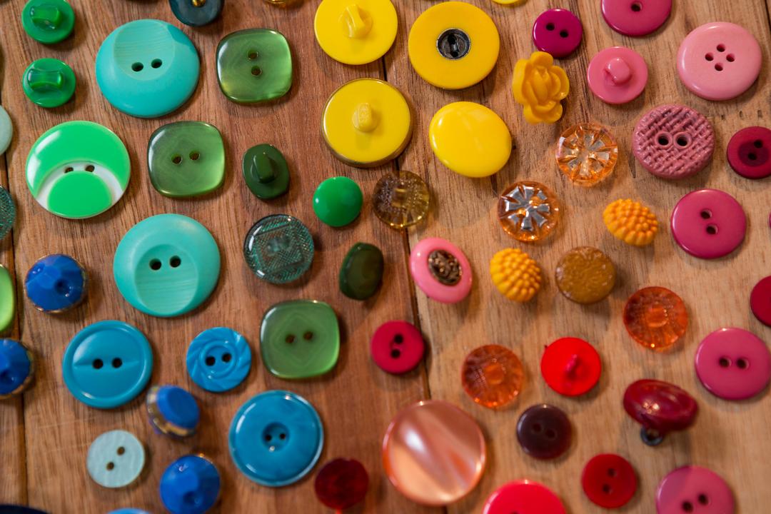 Close-Up of Colorful Assorted Buttons on Wooden Surface - Free Images, Stock Photos and Pictures on Pikwizard.com