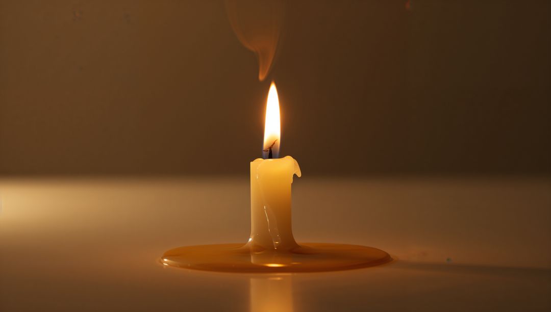 Flickering Candle Flame With Dripping Wax on Reflective Surface