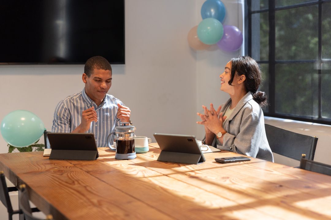 Diverse Team Discussing Project in Modern Office Celebrating Milestones