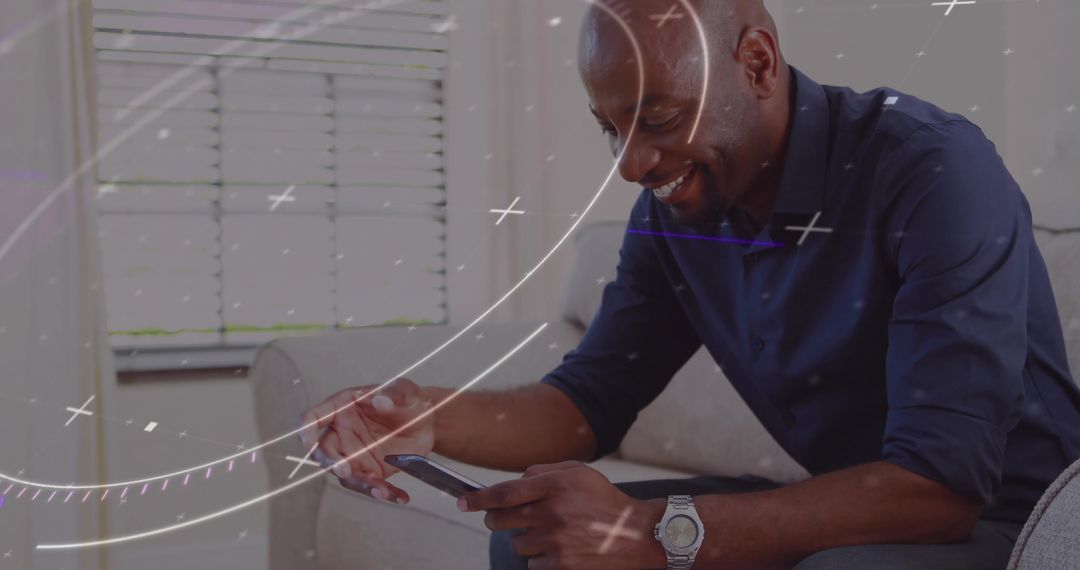 Relaxed Man at Home Enjoys Smartphone Technology on Sofa