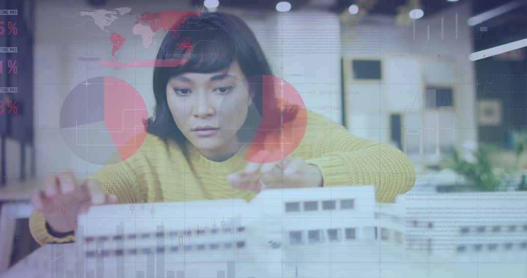 Businesswoman Analyzing Architectural Model with Data Visualizations