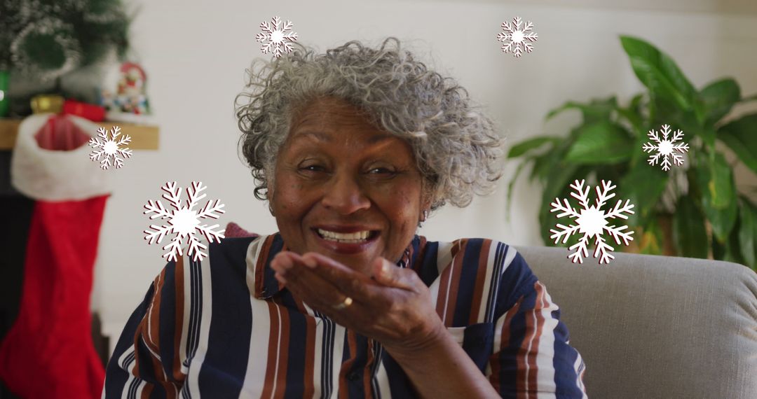 Senior Woman Blowing Kiss Celebrating Holiday Season at Home
