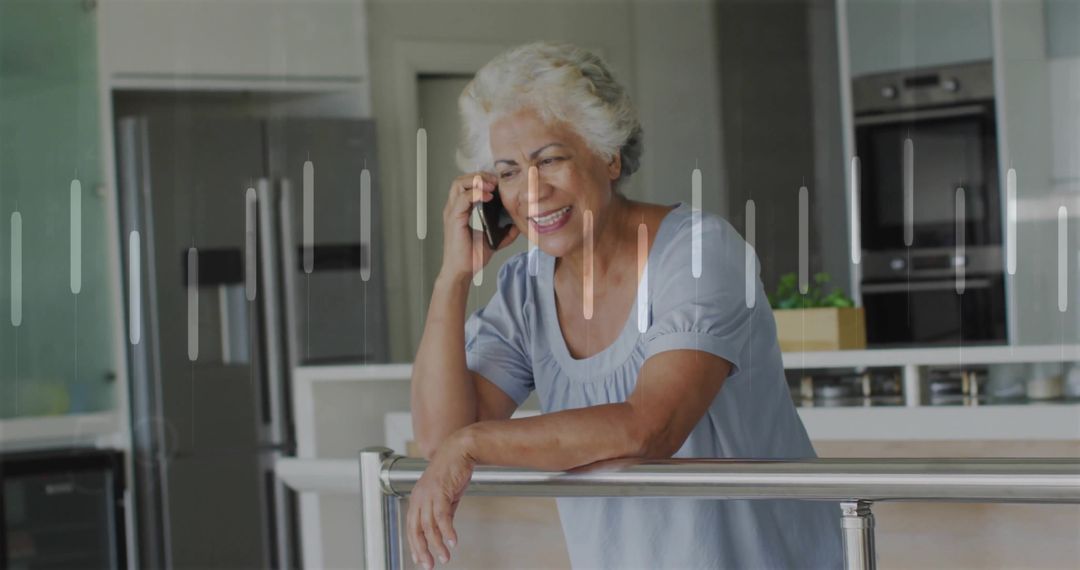 Smiling Senior Woman Using Smartphone in Bright Modern Kitchen