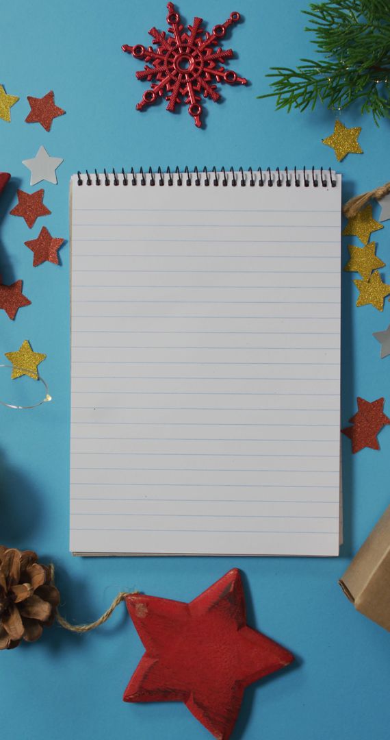 Christmas-Themed Notepad with Festive Decorations on Blue