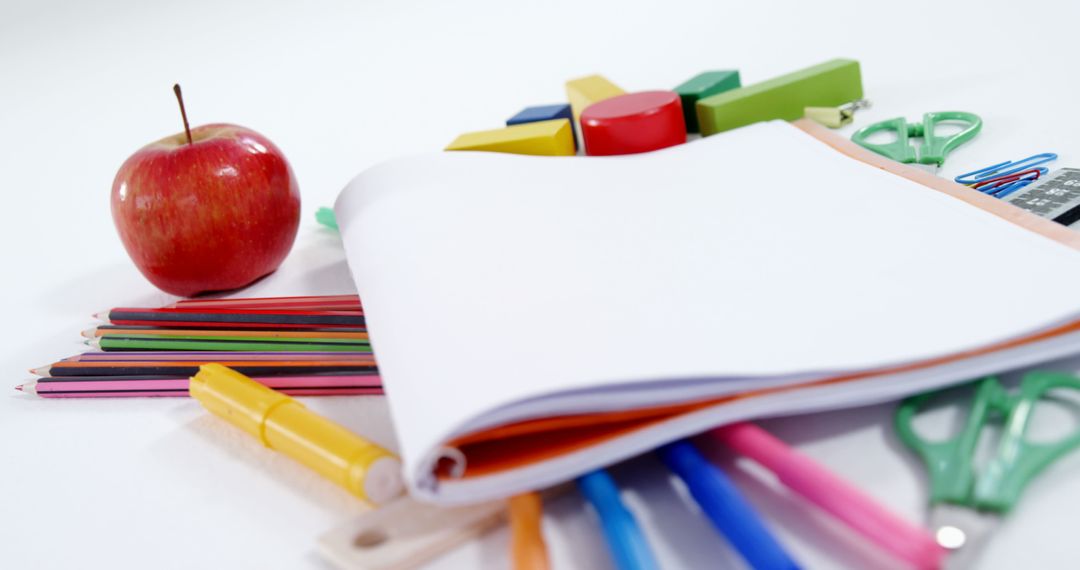 Back-to-School Essentials with Colorful Supplies and Apple