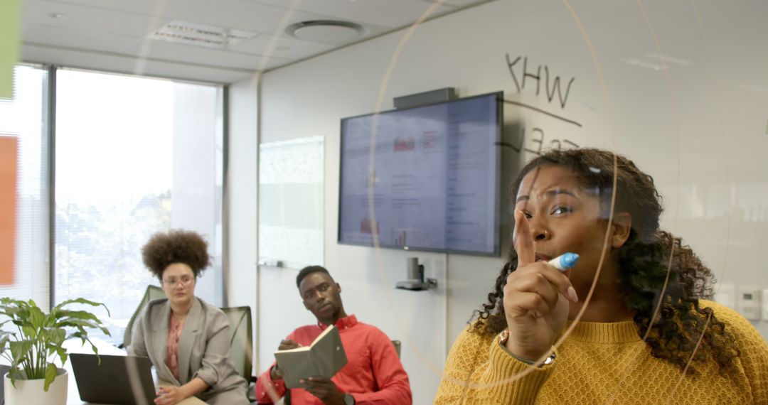 Diverse Team in Office Brainstorming Session on Transparent Screen
