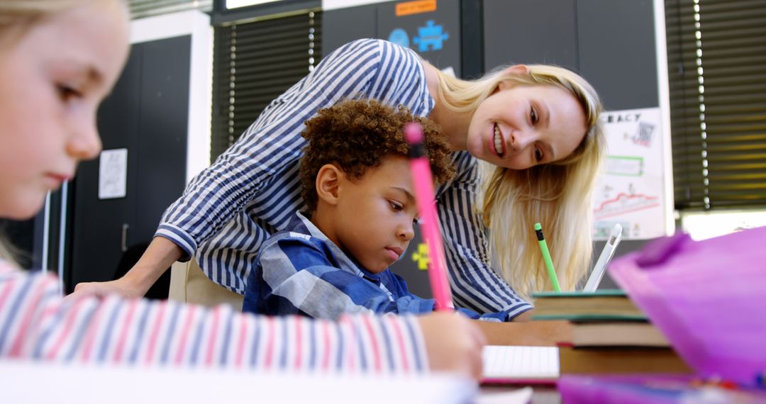 Teacher Helping Young Students During Classroom Activity - Free Images, Stock Photos and Pictures on Pikwizard.com