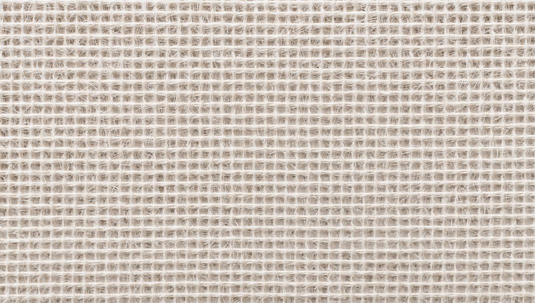 Off-white open-weave textile showing yarn fibers, square grid pattern and soft fibrils