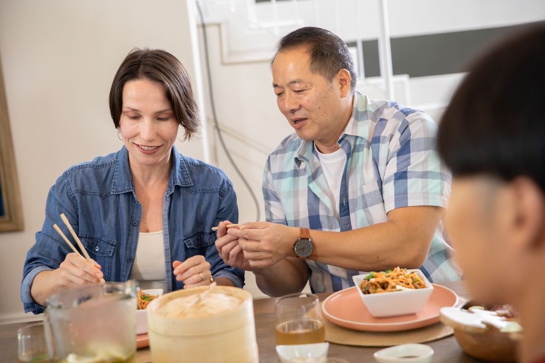 Multi-Generational Family Enjoying Meal at Home Dining Table