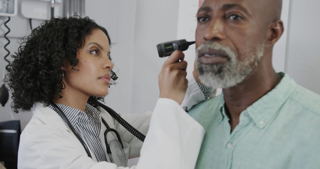 Doctor Examining Elderly Patient’s Ear with Otoscope in Clinic - Free Images, Stock Photos and Pictures on Pikwizard.com