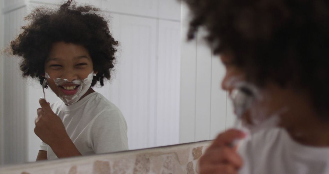 Young Boy Shaving and Smiling at Mirror in Bathroom - Free Images, Stock Photos and Pictures on Pikwizard.com