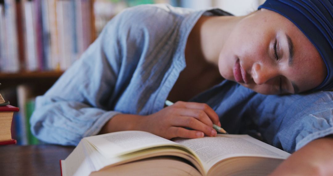 Young Woman Sleeping While Studying in Library, Overworking Concept - Free Images, Stock Photos and Pictures on Pikwizard.com