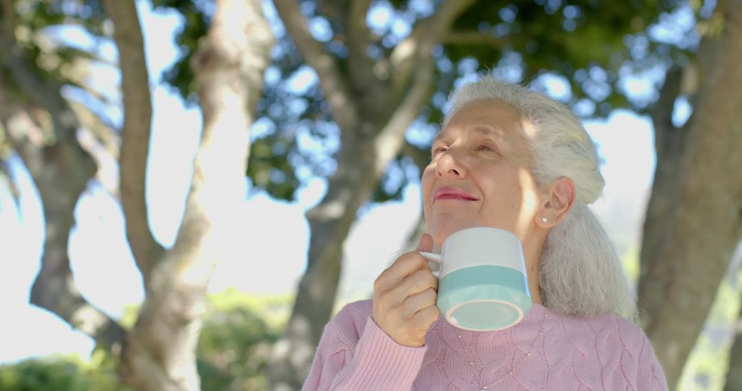 Senior Woman Enjoying Coffee Outdoors in a Garden - Free Images, Stock Photos and Pictures on Pikwizard.com