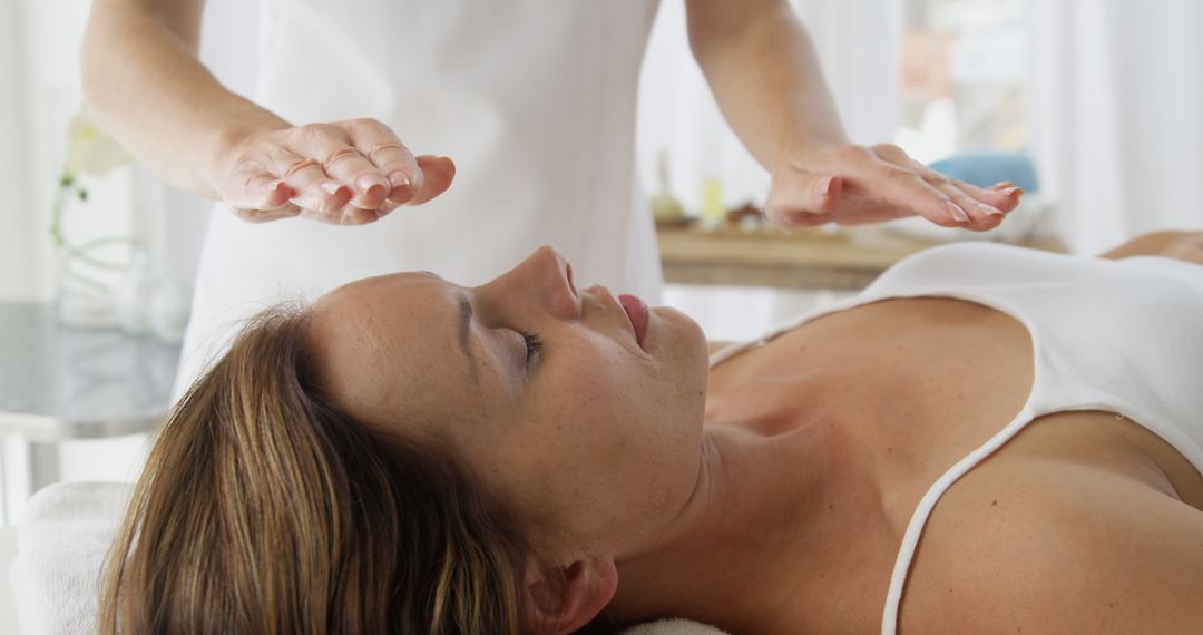 Woman Receiving Reiki Therapy in Wellness Center - Free Images, Stock Photos and Pictures on Pikwizard.com