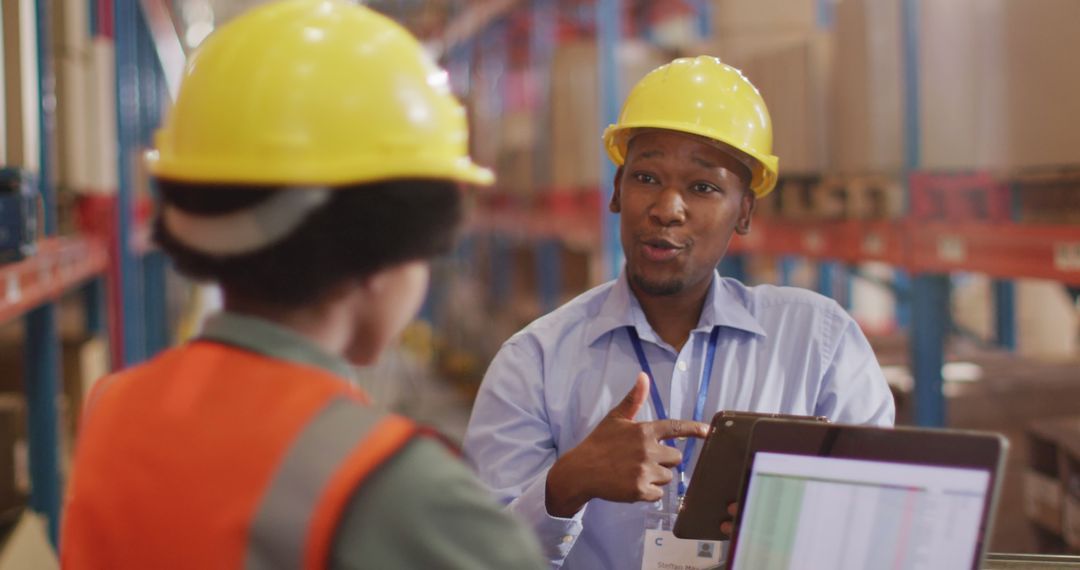 Warehouse Managers Discussing Logistics with Technology