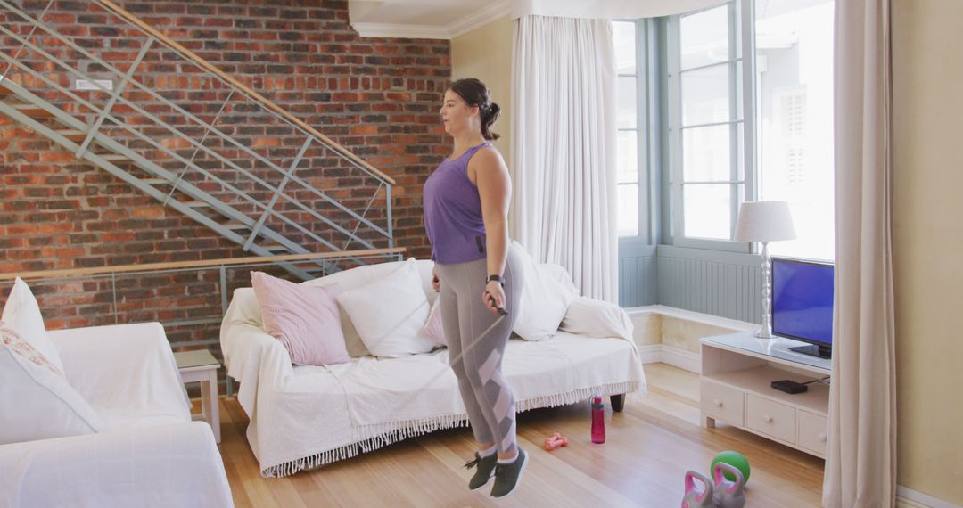 Caucasian female vlogger spending time at home, exercising using a skipping rope - Free Images, Stock Photos and Pictures on Pikwizard.com